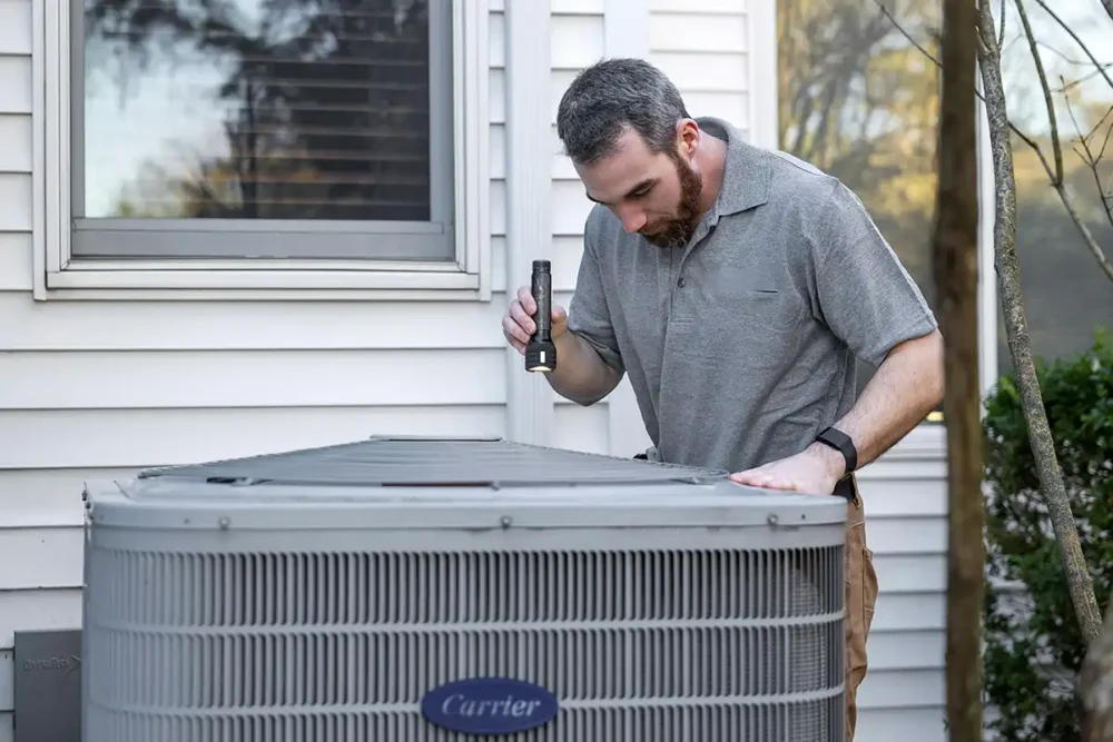 HVAC Technician Inspecting an AC Compressor
