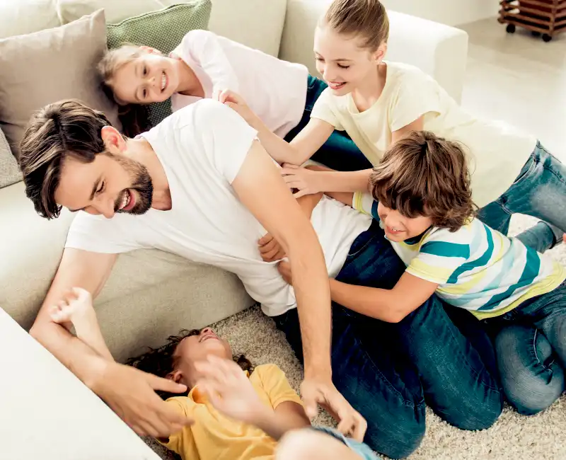 Father Playing with his Kids in Livingroom