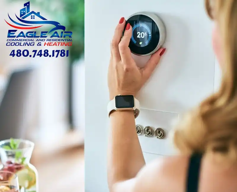 Woman Changing temperature on thermostat